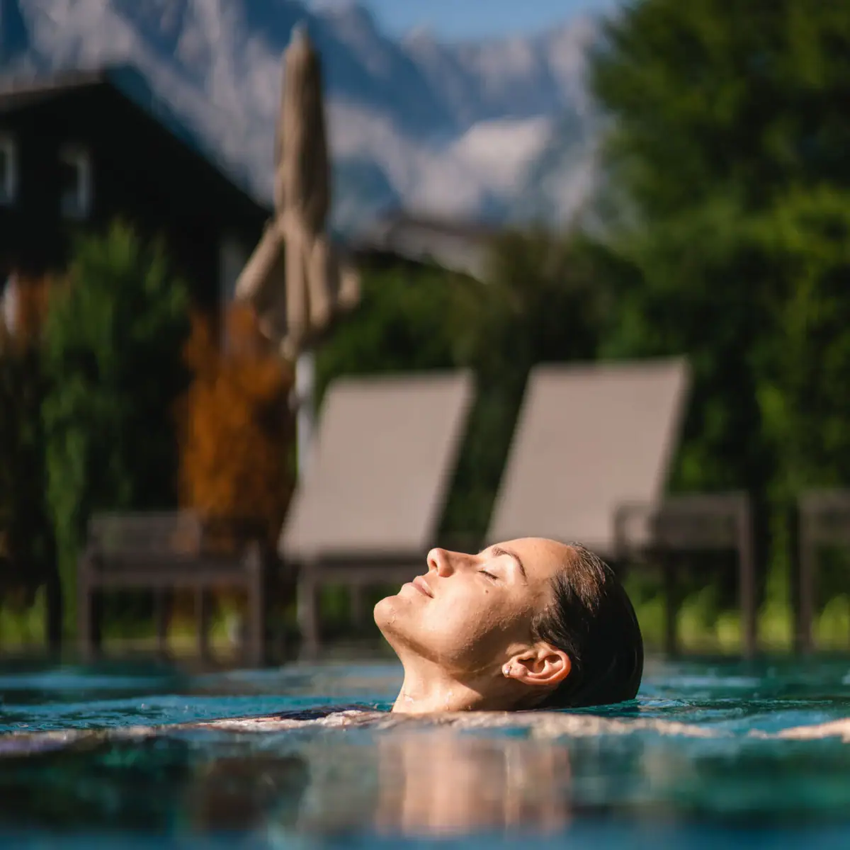 Outdoor pool A woman swims in a pool.