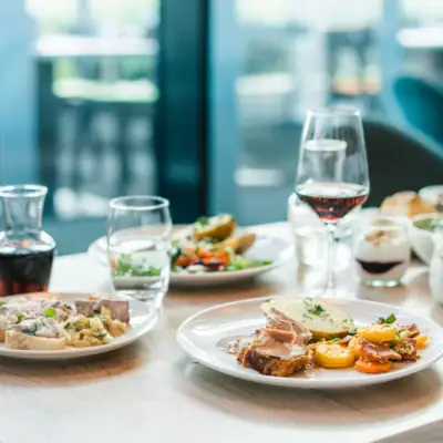 Dinner A table with plates full of food and wine glasses.