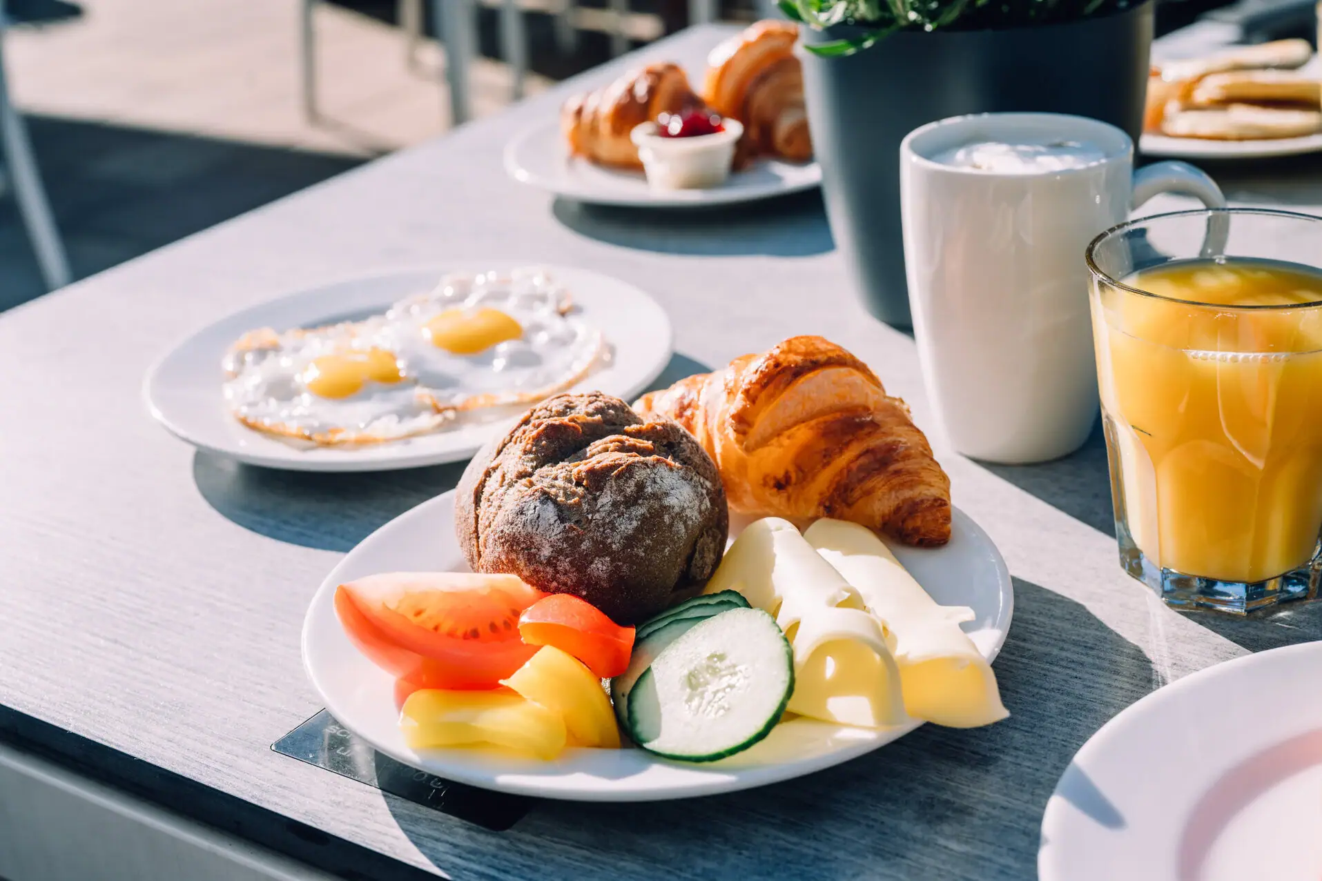 A plate with breakfast on a table.