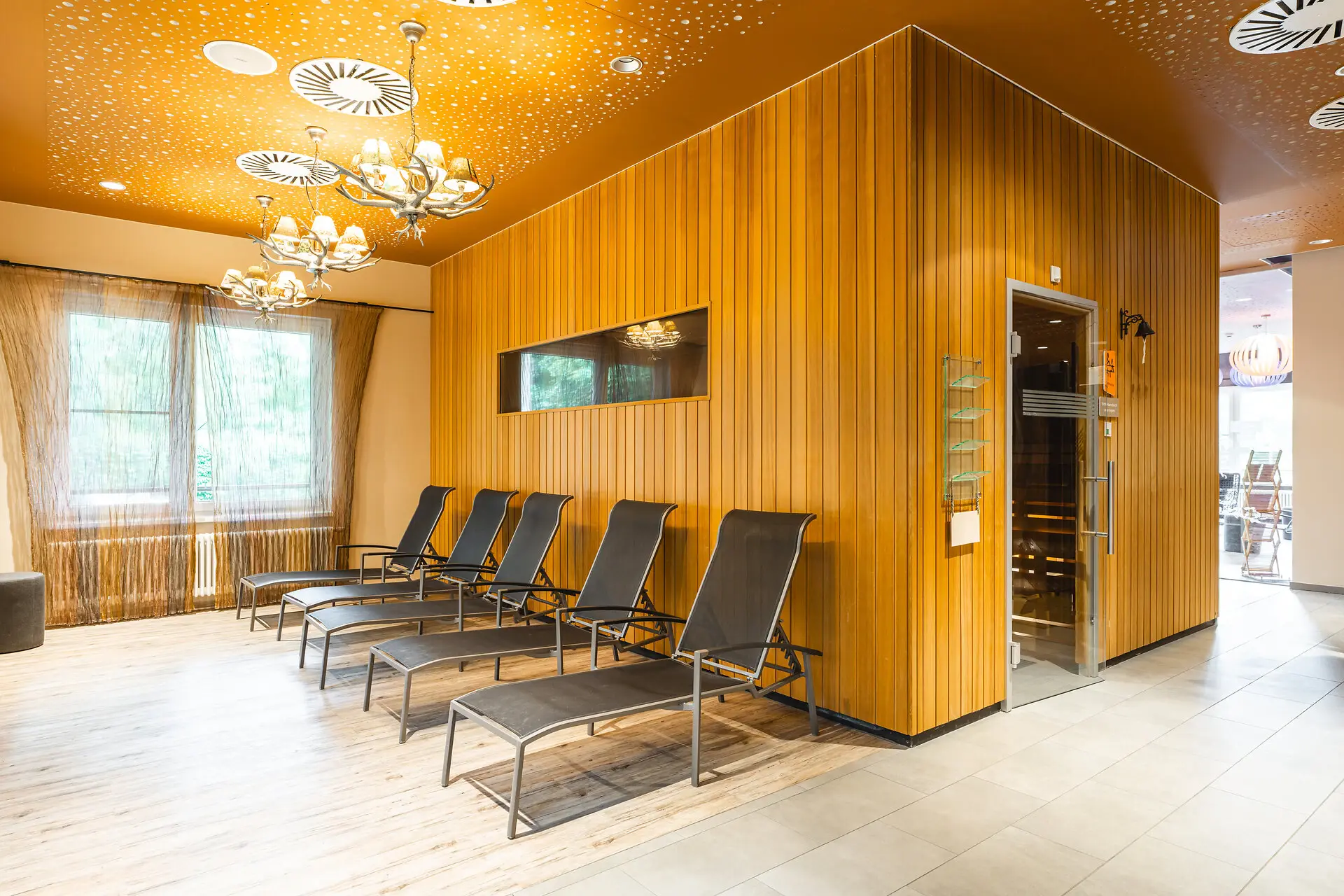 Sauna at aja Bad Saarow A room with chairs and a door.