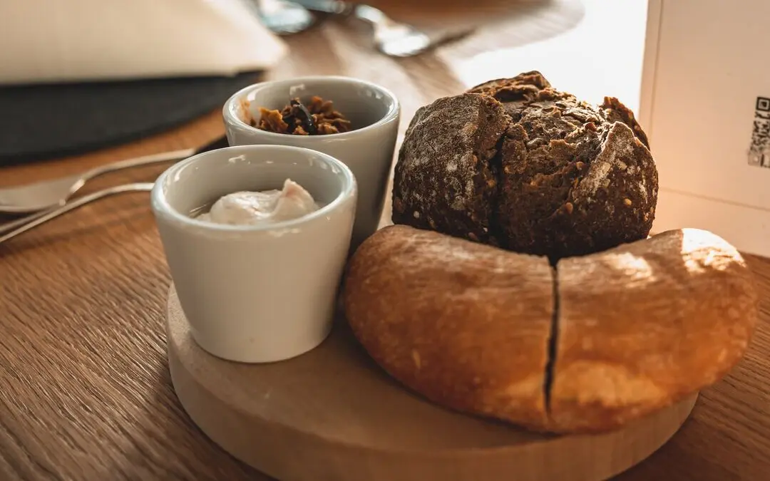 A plate with various pastries and a coffee mug on a table.