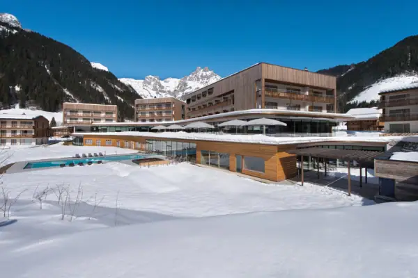 Ein Hotelgebäude mit einem Pool im Schnee.