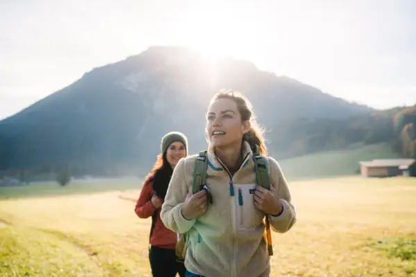 A group of women are walking in a field.