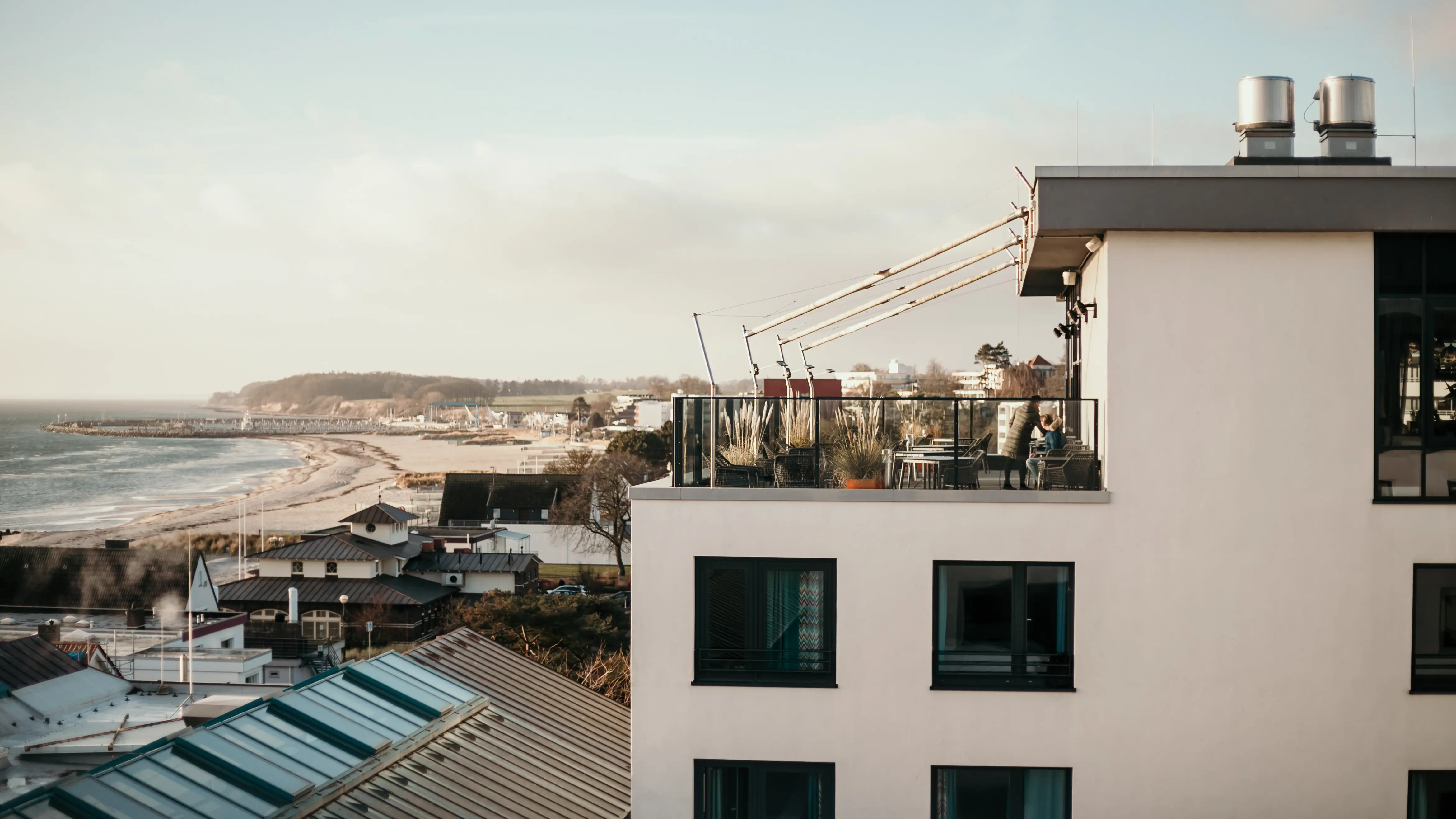 A building with a balcony overlooking a body of water.