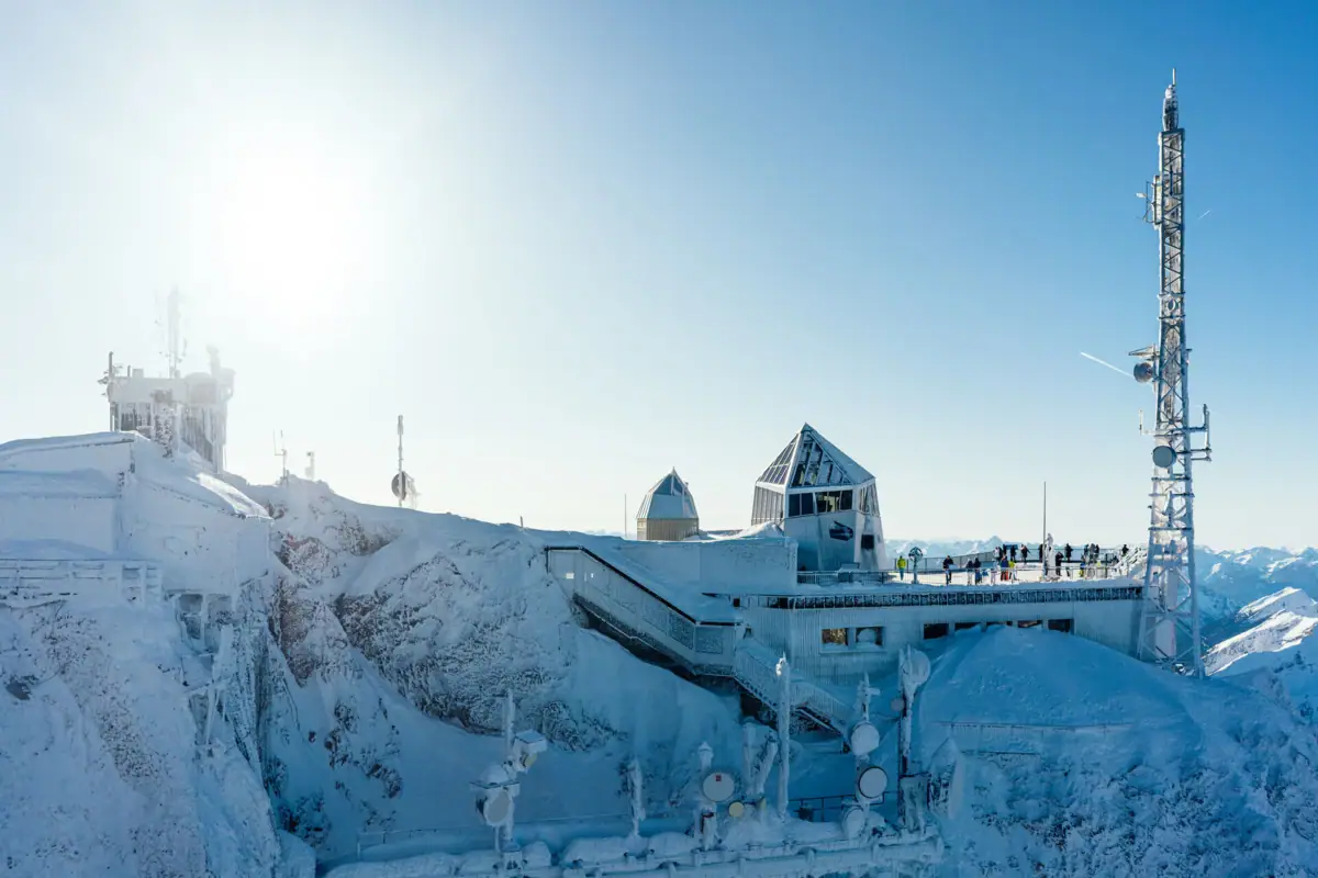 A building with a staircase on a snowy mountain.