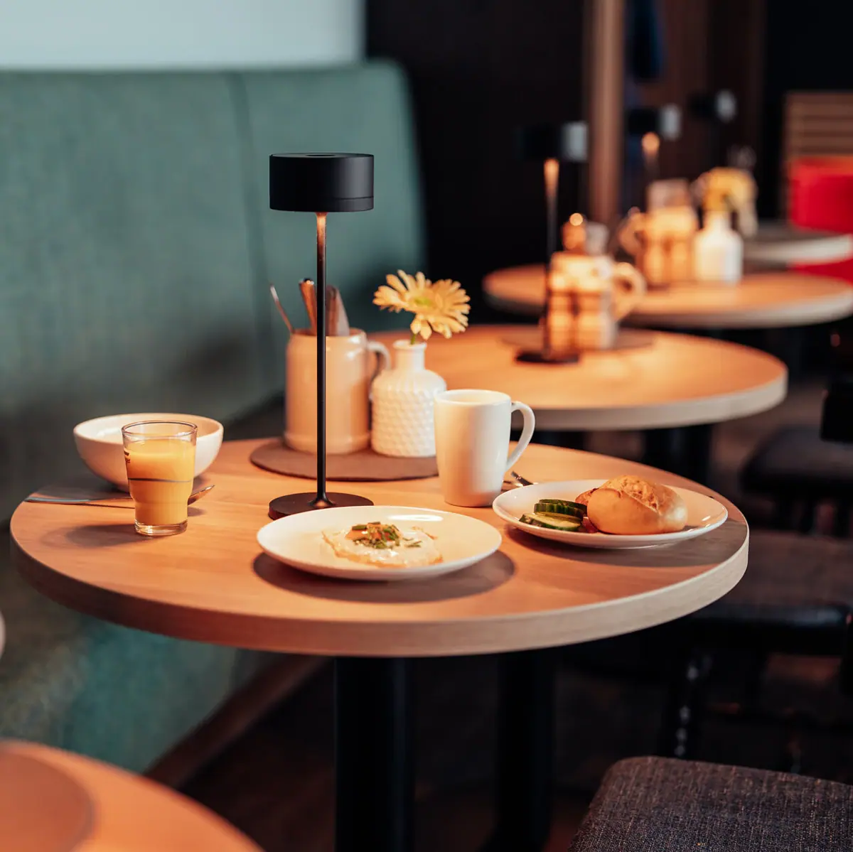 A table with plates of food and various drinks.