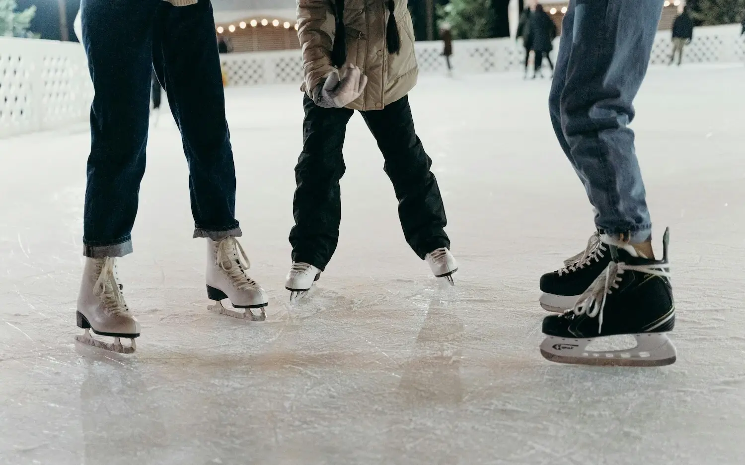 Group of people skating on an ice rink.