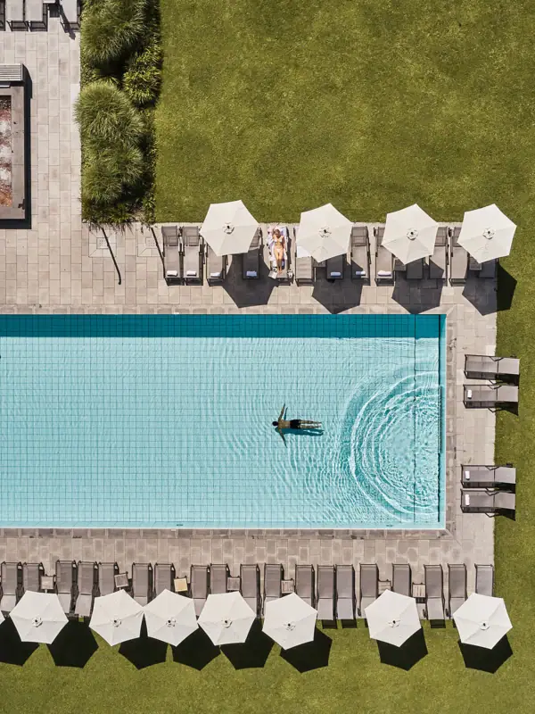 Pool A swimming pool with parasols and lawn.
