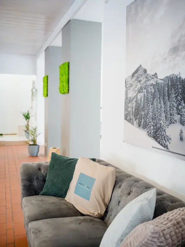 A sofa with cushions in a room