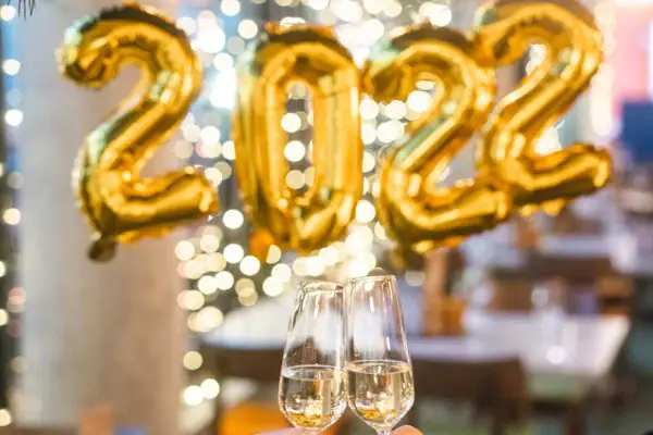 Two people clink glasses of champagne.