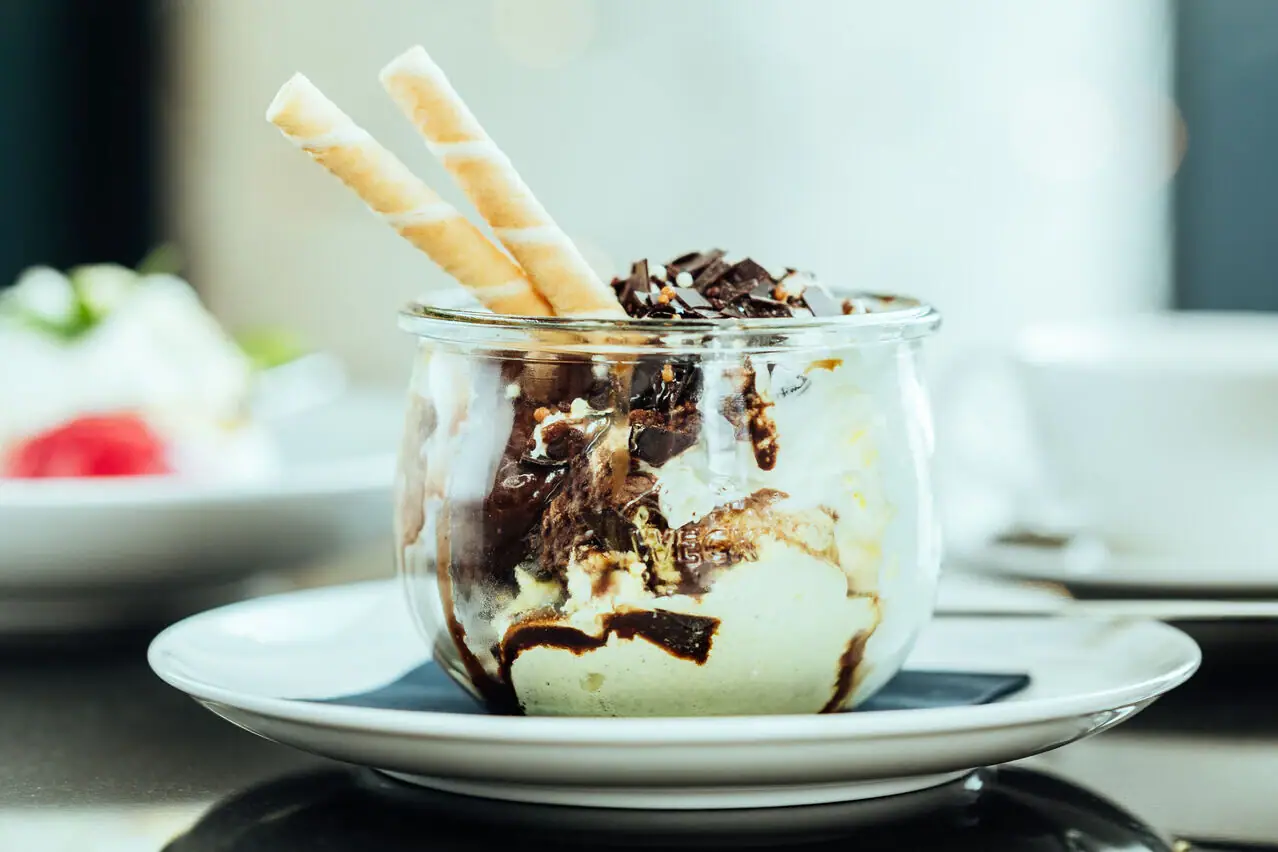 Dessert in a glass jar on a table.