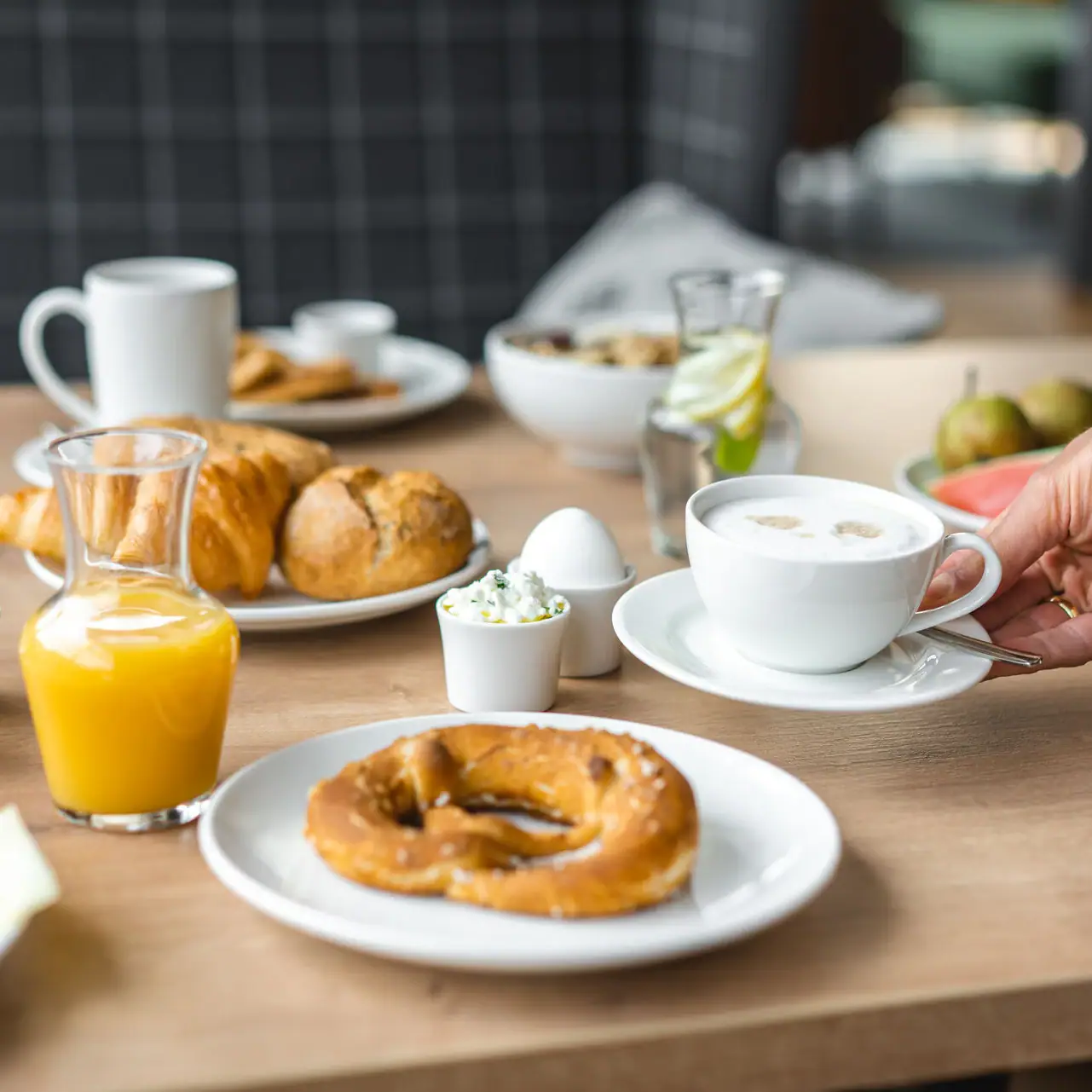 Breakfast A table with various dishes and drinks, including plates, cups and juice.