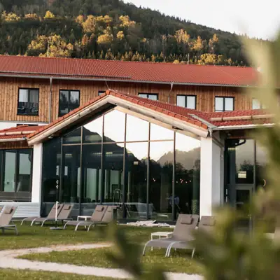 Included services at your aja Hotel A building with a glass wall and chairs in front of it.