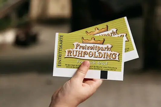 Ticket for the theme park One hand holds two tickets.