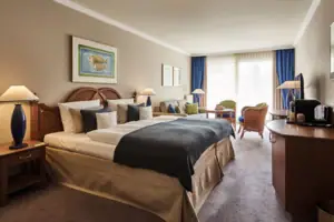 Hotel room with a bed and chairs.