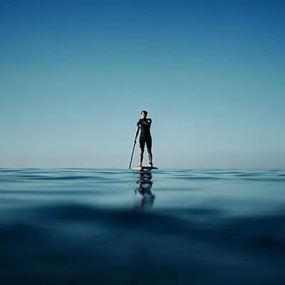 A person on a stand-up paddle board in the ocean.