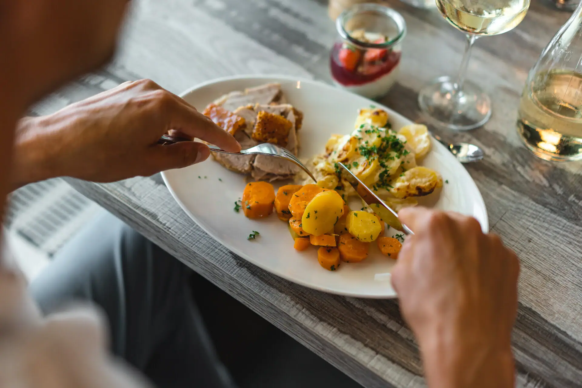 Dish with meat A person eats food from a plate.