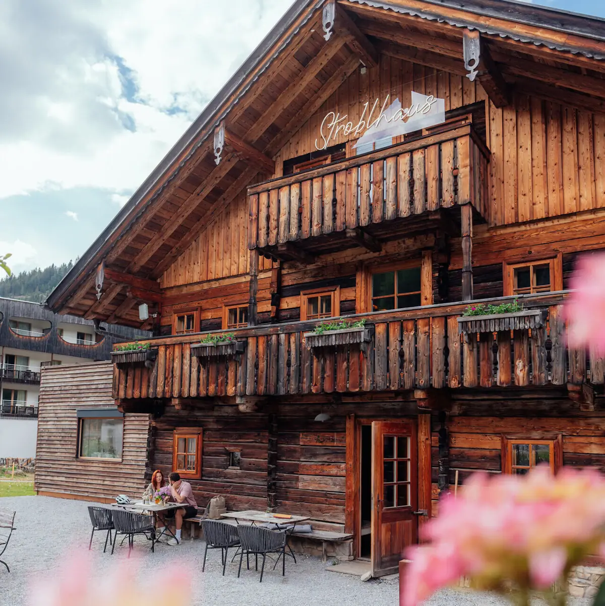 A building with a few people sitting at a table.