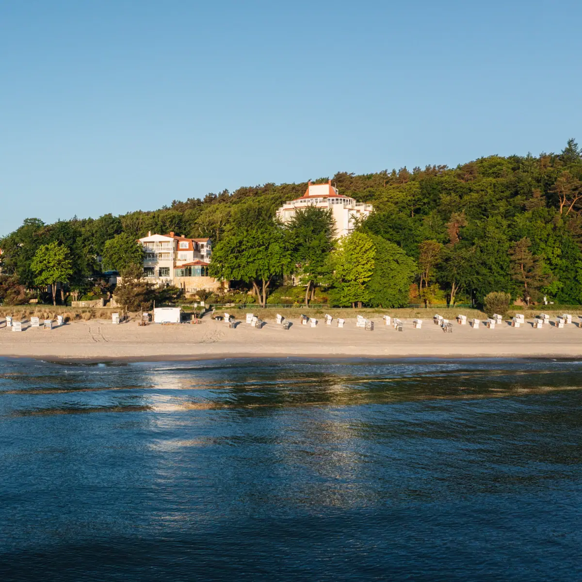 Beach with white buildings and trees
