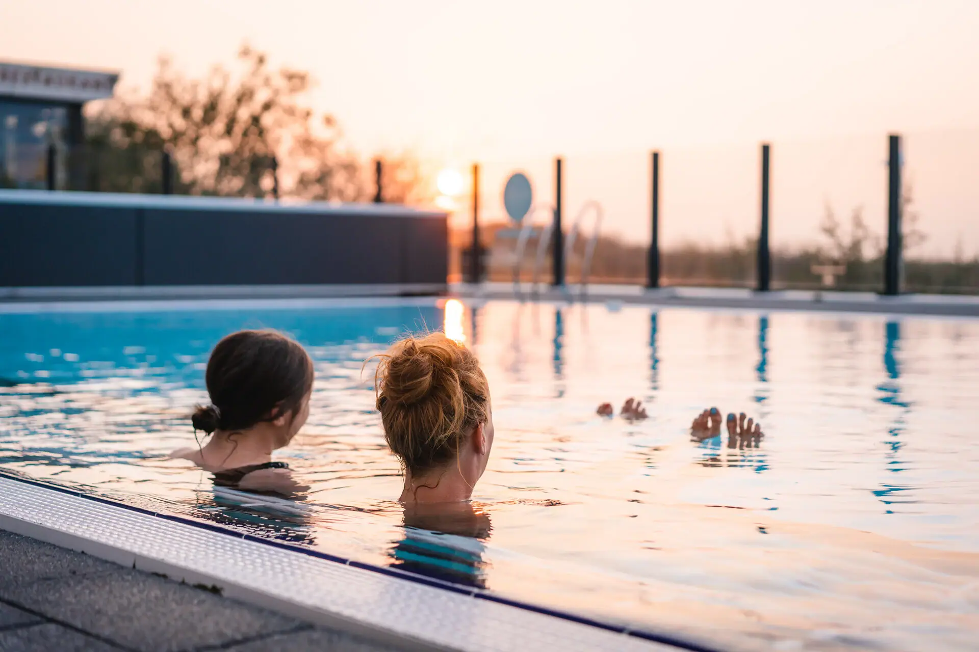 Swimming in the outdoor pool Two women in a swimming pool.