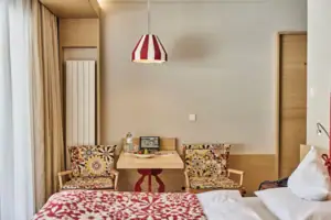 Hotel room A room with a table and chairs.