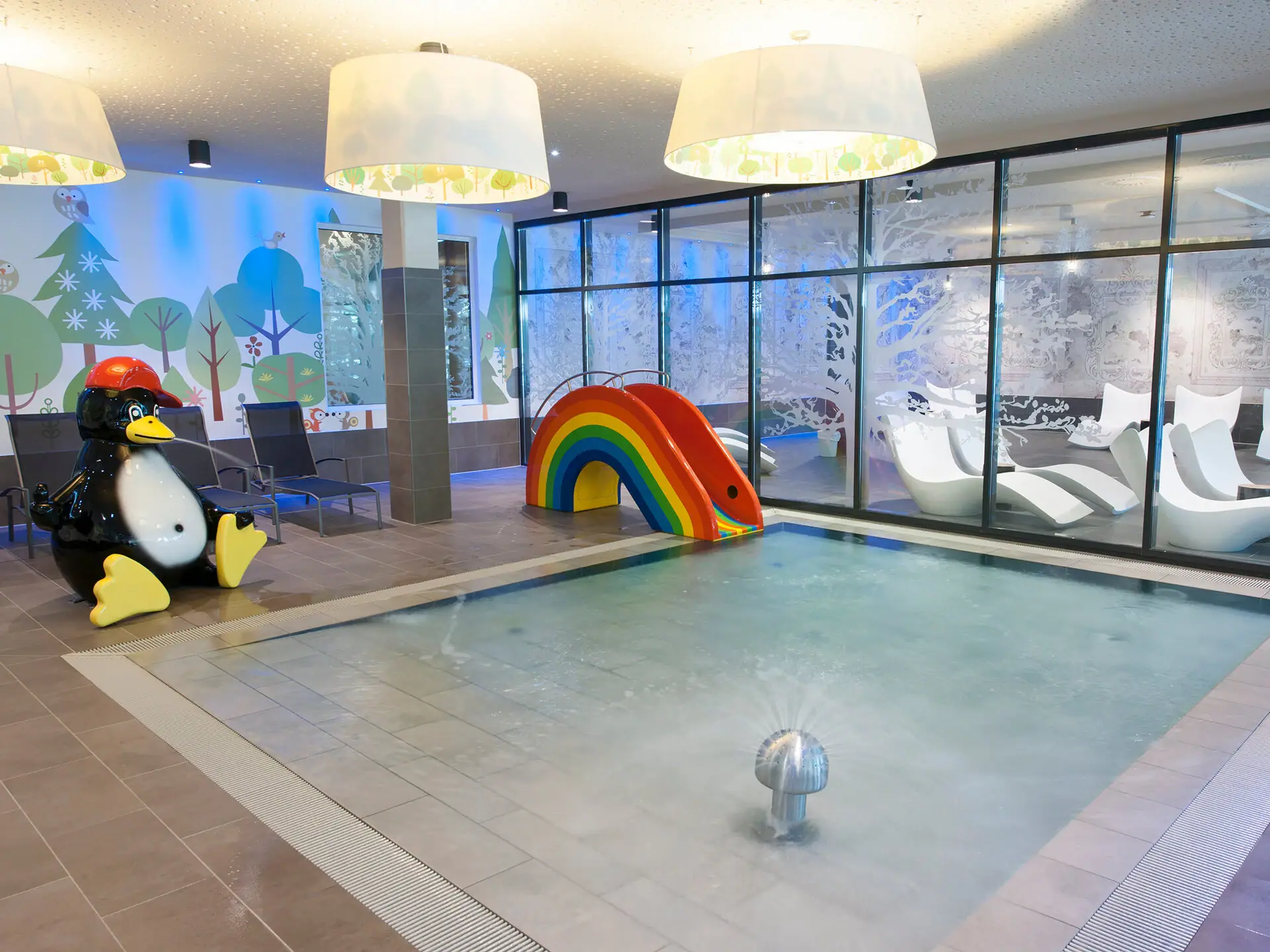 Children's pool at aja Bad Saarow A pool with a slide and a penguin.