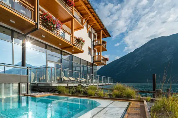 A swimming pool next to a building under a clear sky.