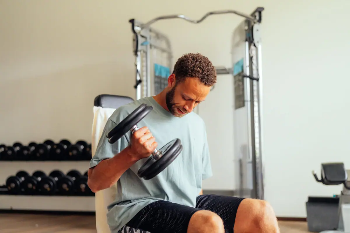 A man is lifting weights in a gym.