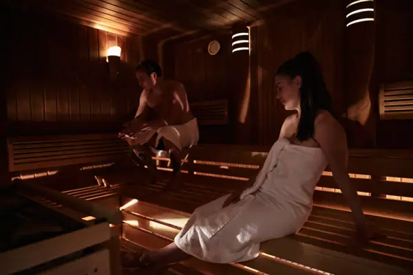 A man and a woman in a sauna.
