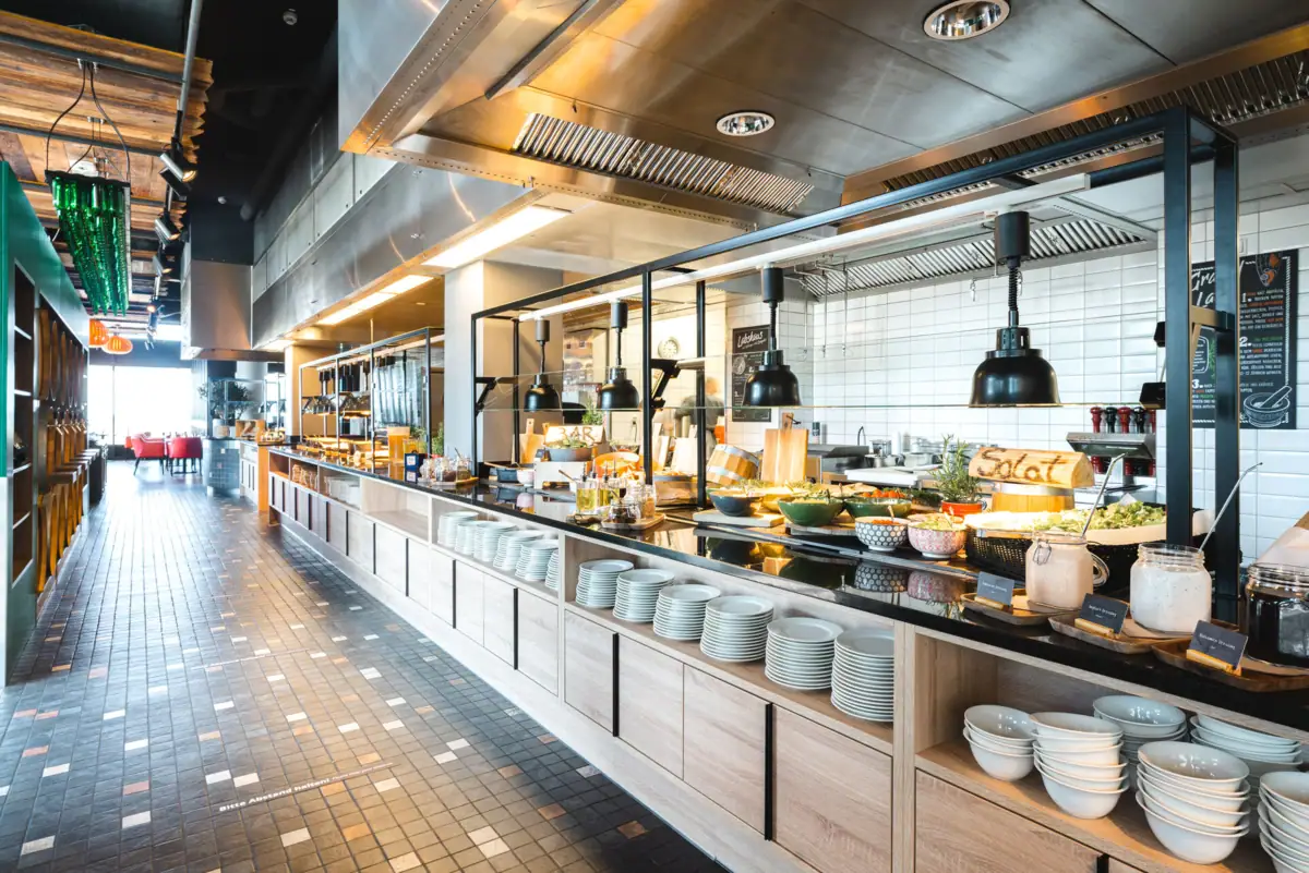 Buffet with plates and bowls on a worktop.