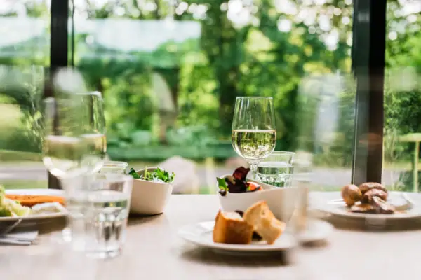 A table with various dishes and wine glasses.