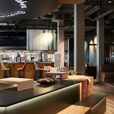 A bar with television and bar stools.