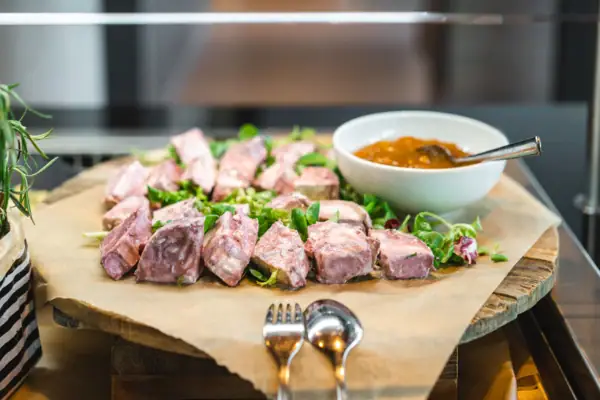 Food on a plate with a bowl of sauce