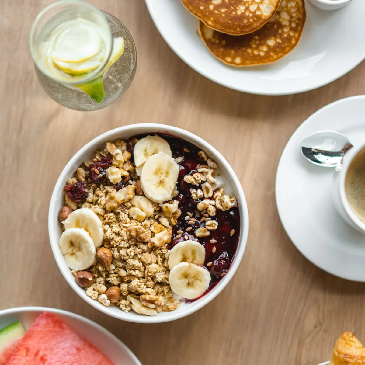 Breakfast A bowl of muesli and a cup of coffee.