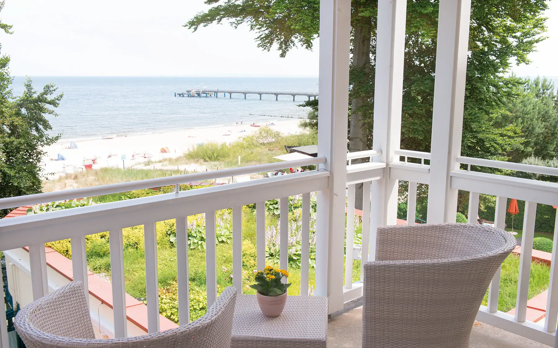 Inviting terrace with chairs and a view of the beach.