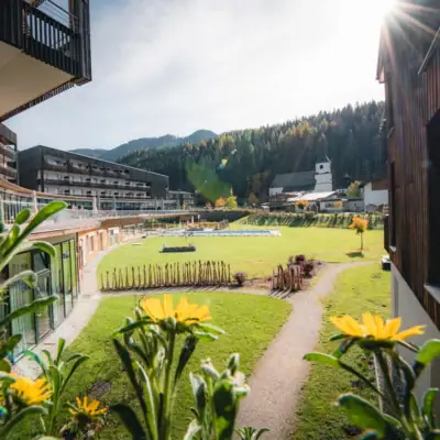 Werfenweng mountain resort Grassy area with buildings and trees in the background