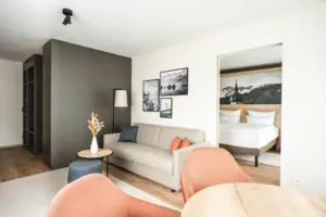 Suite mountain view A room with a sofa and a bed.