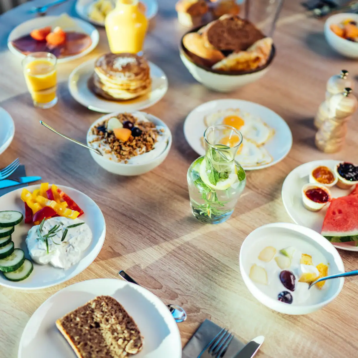 Breakfast table A table with plates full of food and drinks.