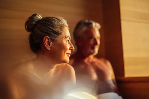 A woman and a man in a sauna.