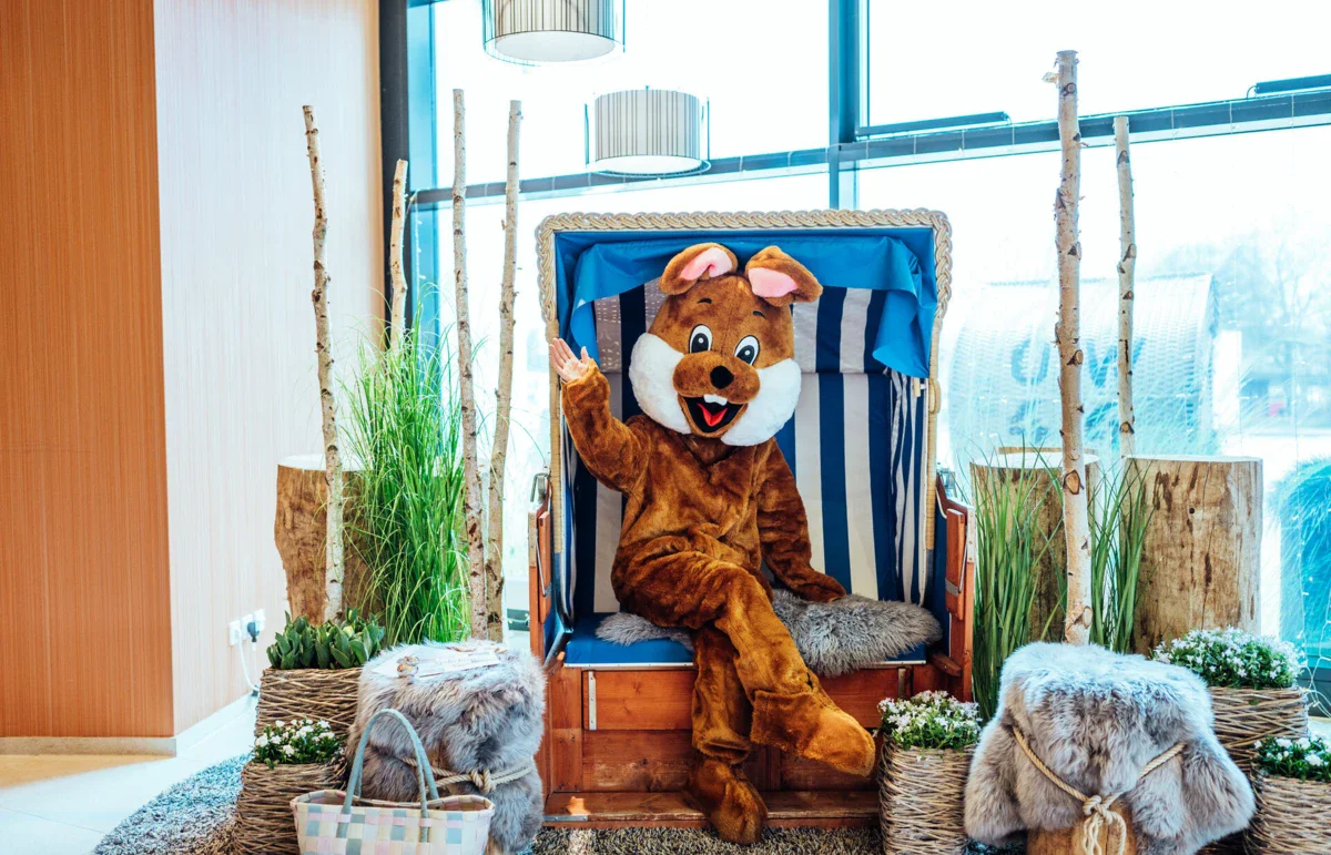 A person in a piece of clothing sits on a chair.