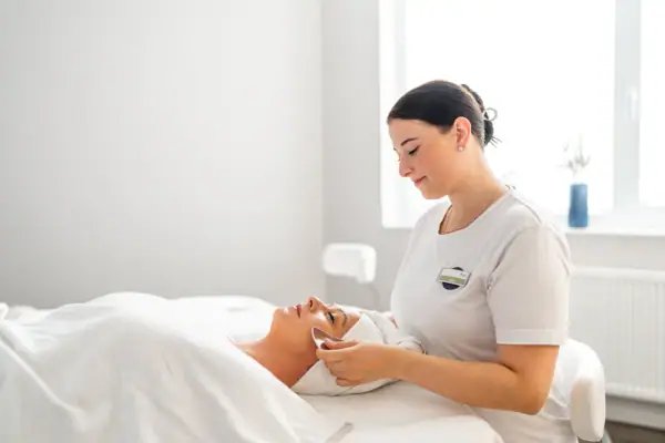 SPA application A woman receives a facial massage.