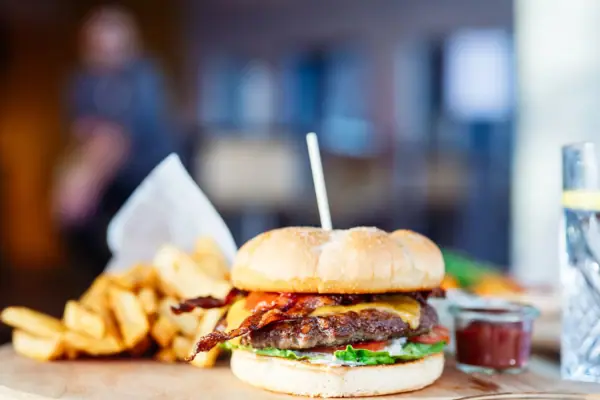 Burger with fries Burgers and fries on a wooden board.