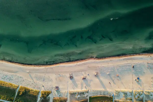 Aerial view of a beach with deckchairs and parasols