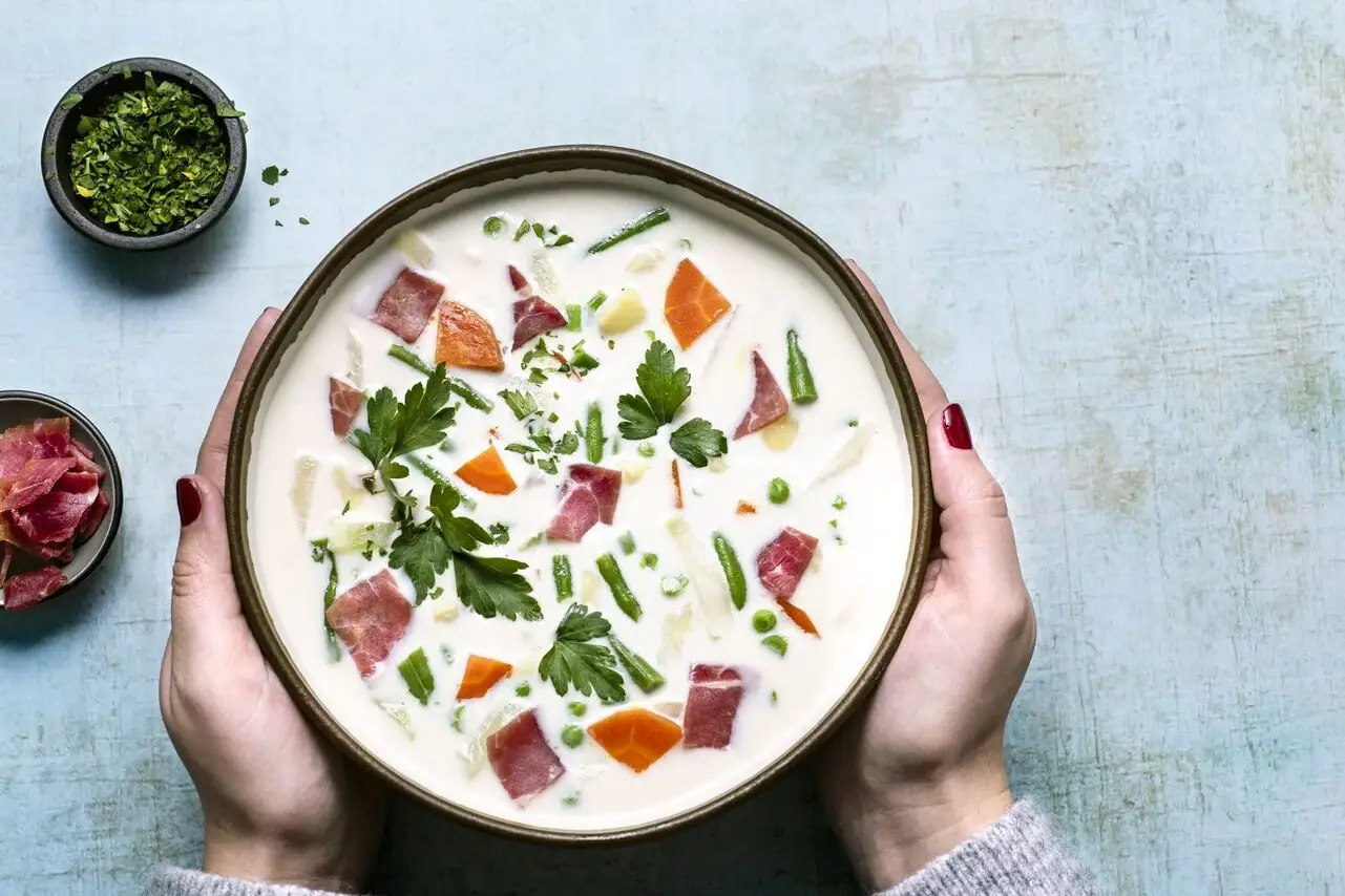 Soup A bowl of soup with vegetables and meat.