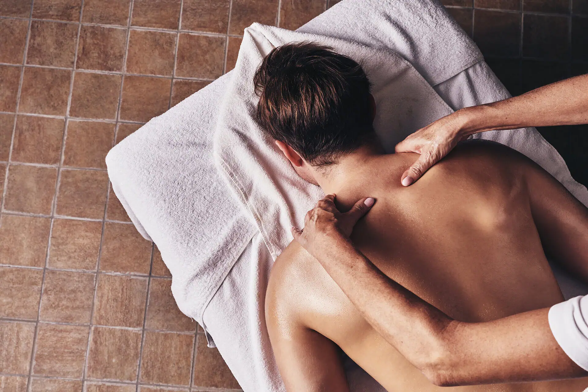 A person is lying on a massage table.