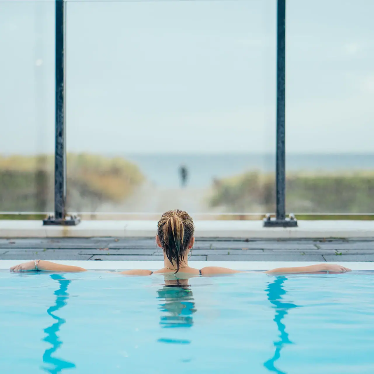 A woman in the outdoor pool.