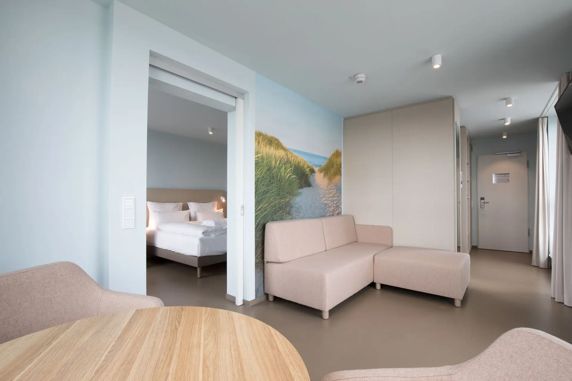 Suite at the aja Travemünde A room with a couch and a bed.