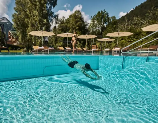 A man swims in a pool.