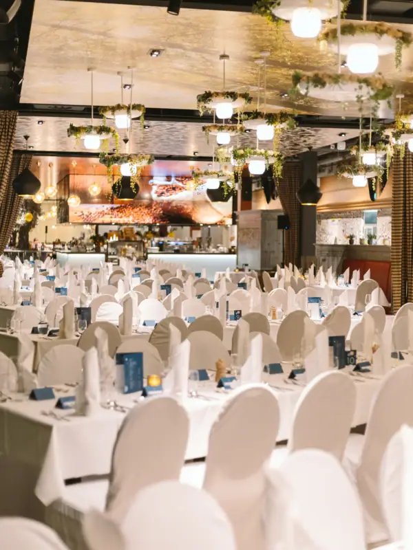 A room with tables and chairs, set up for a party.