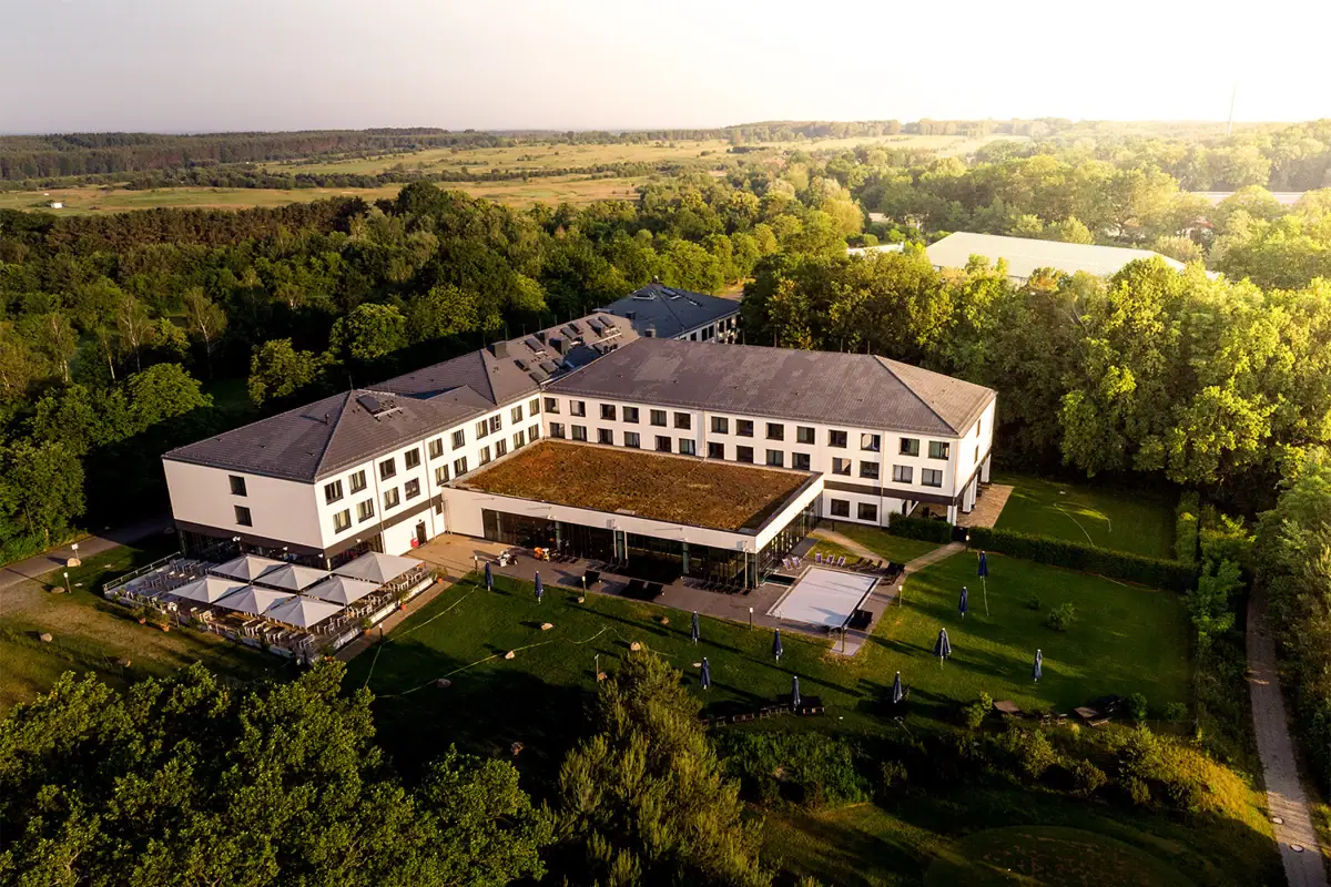 aja Bad Saarow A large white building with trees in the background.